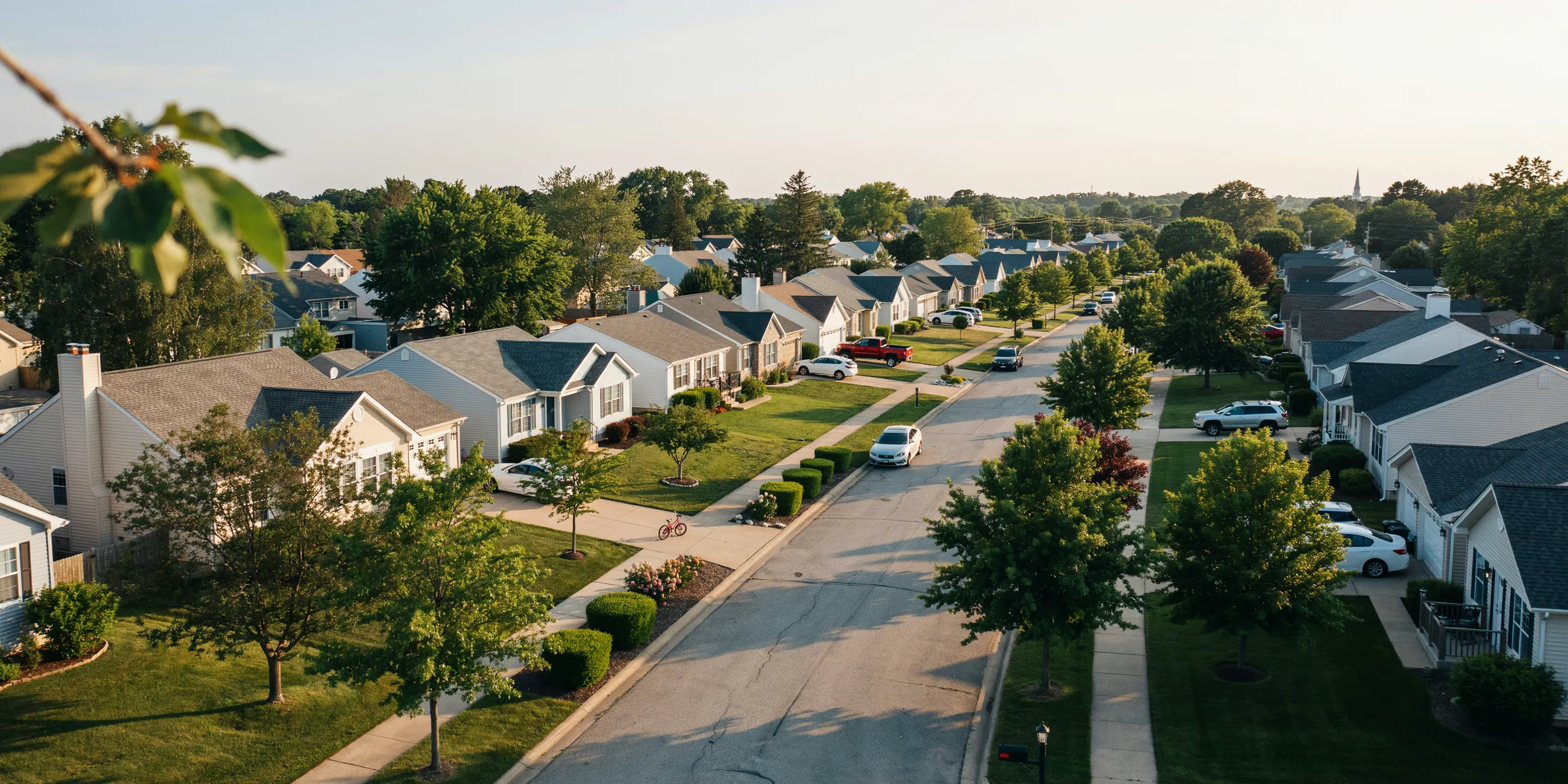 Aerial view of a residential neighborhood at dusk — care that comes to your area